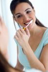 Pretty Young Woman Brushing Her Teeth Stock Photo