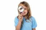 Smiling Kid With Magnifying Glass Stock Photo
