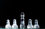King And Several Pawns On Chessboard In Dark Background. Hierarc Stock Photo