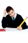 Confused Schoolboy Writing Stock Photo