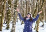 Portrait Of Young Beautiful Woman Playing With Snow In The Woods Stock Photo