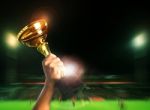 Hand Rising Soccer Football Championship Cup On Sport Competiton In Stadium Background Stock Photo