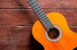 Flamenco Guitar On Wood Background Illuminated By Natural Daylight Stock Photo