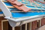 Zinc Gutter And Tiles On Roof Pitch Of House Stock Photo