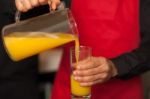 Guy Pouring Fresh Juice In Glass Stock Photo