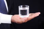 Business Man Holding A Glass Of Water Stock Photo