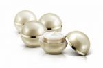 Several Golden Sphere Cosmetic Jar On White Background Stock Photo