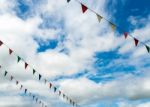 Triangle Flag Hanging On The Rope And Blue Sky Stock Photo