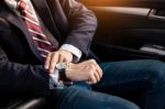 Handsome Businessman Looking On Wrist Watch In Car Stock Photo