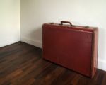 Old Suitcase On Wood Floor Stock Photo