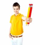 Schoolboy Showing Big Pencils Stock Photo