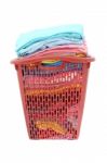 Used Cloths In Old Red Plastic Basket On White Background Stock Photo