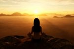 3d Rendering Of Woman Doing Yoga And Meditates On The Mountain Stock Photo