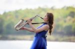 Beautiful Woman Wear Blue Evening Dress Sound Saxophone Over Mou Stock Photo