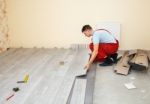 Handyman Laying Down Laminate Flooring Boards Stock Photo