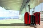 Stack Of Traveling Luggage In Airport Terminal And Passenger Plane Flying For Air Transport And Treveling Theme Stock Photo