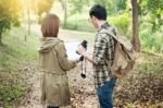 Couple Of Tourists Heading To The Forest With Maps In Hand Searc Stock Photo