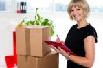 Casual Woman Documenting List Of Goods On Clipboard Stock Photo
