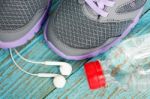 Sport Shoes With Earphones And Drinking Water Stock Photo