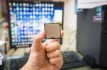 Cpu In Hand With Desktop Pc Computer At Office Background. Soft Focus Stock Photo