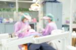 Dentist And Dental Assistants In Hospital ( Blurry Dental Background ) In Thailand Stock Photo