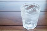 Glass Of Cold Water On Wooden Table Stock Photo