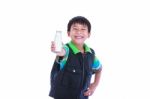 Boy Smiling And Showing Bottle Of Milk, On White Stock Photo