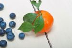 Tangerine And Blueberry On White Table Stock Photo
