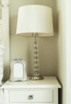 Bedside Table With Lamp, And Picture Frame Stock Photo