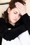 Woman Having Headache At Home Stock Photo