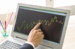Businessman Point And Analyze Forex Graph Or Stock Graph By Right Finger Stock Photo