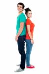 Young Couple Posing Back To Back Stock Photo