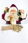 Santa Claus With Gifts And Money Coins Stock Photo
