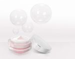 Pink Triangle Cosmetic Jar On Bubble Background Stock Photo