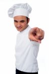 Smart Young Chef Pointing At Camera Stock Photo