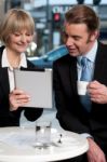 Cheerful Business People Using Digital Tablet Stock Photo