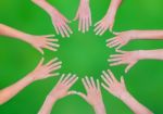 Five Children Hands Joining In Circle Above Green Background Stock Photo