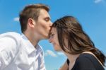 Young Attractive Caucasian Couple Man Kisses Woman On Forehead Stock Photo