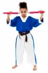 Young Girl In Karate Uniform Holding Nunchucks Stock Photo