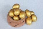 Stack Of Golden Easter Egg In Baked Clay Bowl Stock Photo