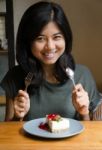 Young Beautiful Woman With A Cake In Cafe Stock Photo