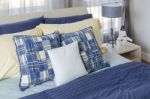 Modern Bedroom With Blue Bed And Yellow Pillows Stock Photo
