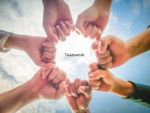 Soft And Blurred Close Up Of Hands Gesturing Unity Under Blue Sky Stock Photo