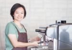 Asian Barista Smiling And Making Cup Of Coffee Stock Photo