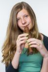 Blonde Teenage Girl Playing The Flute Stock Photo