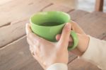 Woman Hand On Hot Green Tea Drinking Stock Photo