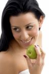 Portrait Of Smiling Female Holding Apple Stock Photo