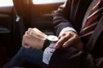 Handsome Businessman Looking On Wrist Watch In Car Stock Photo