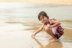 Asian Girl Sitting On Beach Stock Photo