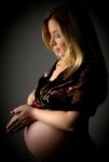 Pregnant Female With Joined Hands Stock Photo